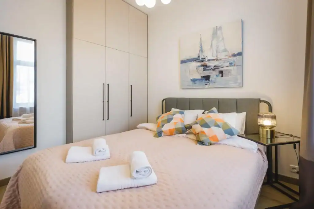 Bright one-bedroom apartment in Riga with cozy bed and modern decor.