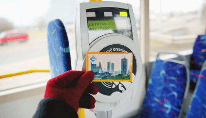 Public transport ticket machine in Riga with cityscape card for travel.